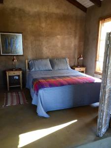 Łóżko lub łóżka w pokoju w obiekcie Eco Lodge Valle de los Artistas, Colchagua, Lolol