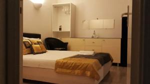 a bedroom with a bed with a mirror and a chair at ZenGarden Pool,3bedrooms,lit bébé Beach800m,box&wifi in Antibes +41 photos