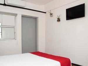 Postel nebo postele na pokoji v ubytování Hotel Allende 104