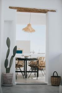 a dining room with a table and chairs at HORA SUITES in Naxos Chora +38 photos