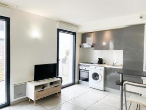 トゥールーズにある003 - Appartement Moderne et Terrasse - Jeanne d'Arc, Toulouseのキッチン(テレビ、洗濯機付)