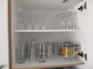 a shelf with many glass jars on it at De Haan - Dahlia 007 in De Haan