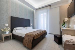 Postel nebo postele na pokoji v ubytování Hotel Stella D'Oro