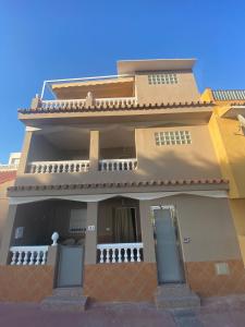 a house with two doors and a balcony at Apartamentos Maria in Málaga