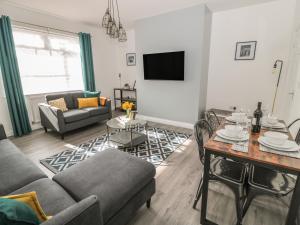 a living room with a couch and a table at Pebble Cove in Morpeth