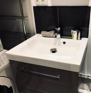 a bathroom with a white sink in a room at Studio avec toit terrasse privé, en centre ville - 004 in Rouen