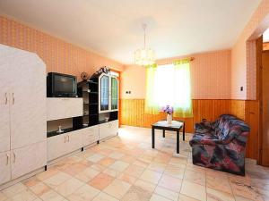 a living room with a couch and a television at Holiday home in Balatonlelle 40449 in Balatonlelle