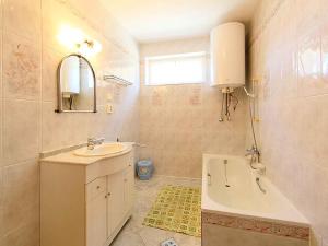 a bathroom with a sink and a bath tub at Holiday home in Balatonlelle 40449 in Balatonlelle +10 photos
