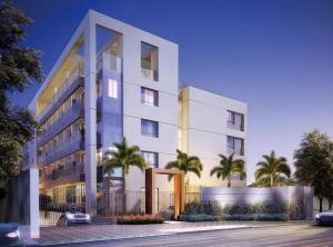 科蒂亞的住宿－Flat Completo，一座白色的大建筑,前面有棕榈树