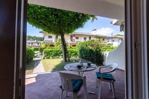 a table and chairs on a patio with a view at Holiday home Porto Santa Margherita 40296 in Porto Santa Margherita di Caorle