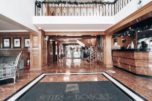 a hotel lobby with a bar and a staircase at Suites del Bosque Hotel in Lima