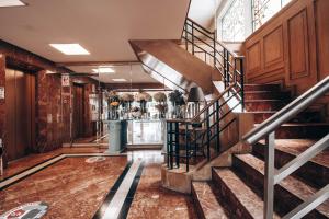 a staircase in a room with a bar at Suites del Bosque Hotel in Lima