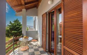 a patio with a table and chairs on a balcony at Apartments Karlobag - Velebit Riviera 39571 in Karlobag +6 photos