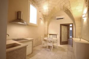 a kitchen with a table and a dining room at La Suite di Martina in Lecce +12 photos