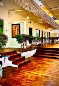 a lobby with stairs and potted plants in a building at Koh Larn White House in Ko Larn