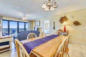 a dining room and living room with a table at Commodore Resort #703 by Book That Condo in Panama City Beach