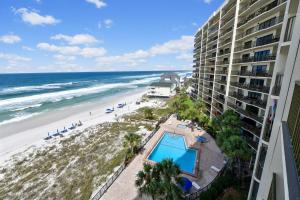 a view of the beach from the balcony of a resort at Commodore Resort #703 by Book That Condo in Panama City Beach