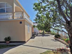 a building with a balcony on the side of it at Apartment in Baric Draga 38614 in Barić Draga