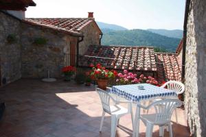 a patio with a table and chairs and a building at Apartment in Montieri/Toskana 38264 in Montieri