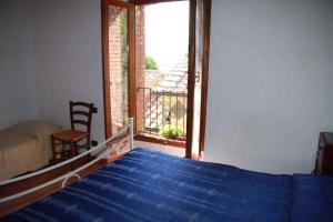 a bedroom with a bed and a window with a view at Apartment in Montieri/Toskana 38264 in Montieri