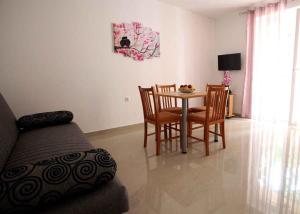 a living room with a couch and a table and chairs at Apartment in Vrbnik/Insel Krk 36872 in Vrbnik