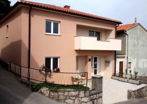 a house with a fence in front of it at Apartment in Vrbnik - Insel Krk 36872 in Vrbnik