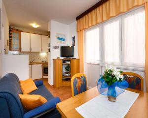 a living room with a blue couch and a table at Apartment in Vrbnik/Insel Krk 36851 in Vrbnik