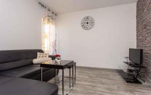 a living room with a couch and a table at Apartment in Vrbnik/Insel Krk 36800 in Vrbnik