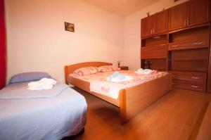 a bedroom with two beds and a dresser at Studio in Vrbnik/Insel Krk 36786 in Vrbnik