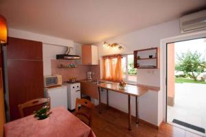 a kitchen with a table and a counter top at Studio in Vrbnik/Insel Krk 36786 in Vrbnik