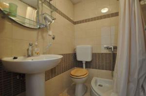 a bathroom with a sink and a toilet and a sink at Apartment in Vrbnik/Insel Krk 36796 in Vrbnik