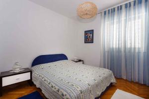 a bedroom with a bed and a large window at Apartments in Vrbnik/Insel Krk 36771 in Vrbnik