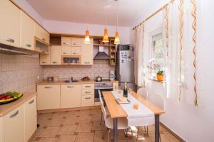 a kitchen with a table and chairs in a room at Apartment in Vrbnik/Insel Krk 36842 in Vrbnik