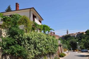 a house on the side of a stone wall at Apartment in Vrbnik/Insel Krk 36796 in Vrbnik