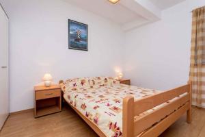 a bedroom with a bed and two night stands at Apartment in Vrbnik/Insel Krk 36856 in Vrbnik