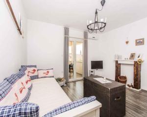 a living room with a bed and a couch at Apartment in Vrbnik/Insel Krk 36858 in Vrbnik