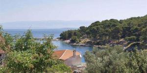 a view of a river with houses and the ocean at Apartment in Veli Losinj 36509 in Veli Lošinj