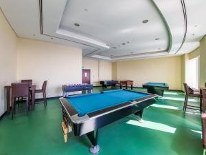 a pool table in a room with tables and chairs at Luxury Rooms In The Tallest Tower In Marina-BeachFront Atlantis & Skydive View in Dubai