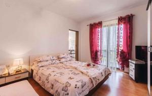 a bedroom with a large bed with red curtains at Apartment in Koromacno - Istrien 33192 in Koromačno