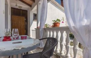 a white balcony with a table and chairs and a window at Apartment in Koromacno - Istrien 33192 in Koromačno