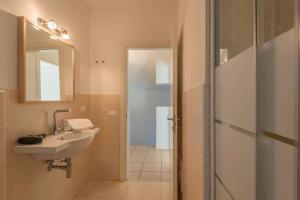 a bathroom with a sink and a mirror at Holiday home in Baja Sardinia 30355 in Baja Sardinia +15 photos