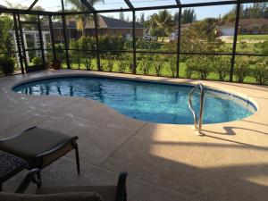 a small swimming pool with a chair next to it at Villa Andromeda in Cape Coral
