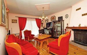 a living room with red furniture and a fireplace at Holiday home in Donji Prolozac 27078 in Donji Proložac