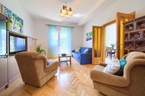 a living room with two chairs and a television at Apartment in Vrbnik/Insel Krk 35995 in Vrbnik