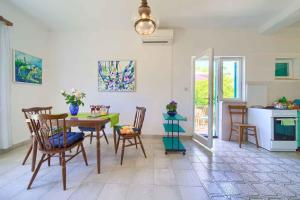 a kitchen and dining room with a table and chairs at Apartment in Vrbnik/Insel Krk 35995 in Vrbnik