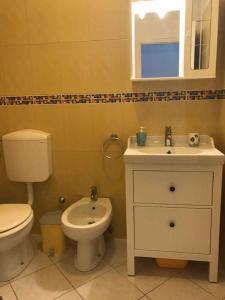 a bathroom with a white toilet and a sink at Apartments in Hvar/Insel Hvar 33535 in Hvar