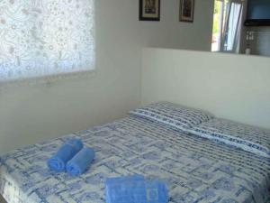 a bed with two blue towels on top of it at Apartments in Hvar/Insel Hvar 33535 in Hvar