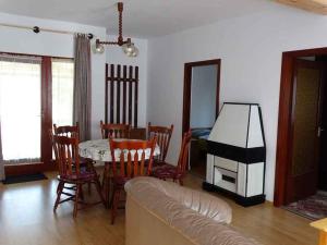 a living room with a couch and a table and a tv at Holiday home in Balatonfenyves 18431 in Balatonfenyves