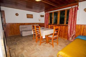 a dining room with a table and chairs in a room at Holiday home Podbanske - Hohe Tatra 26186 in Pribylina