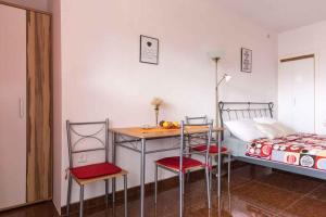 a bedroom with a table and chairs and a bed at Studio in Vrbnik/Insel Krk 35988 in Vrbnik